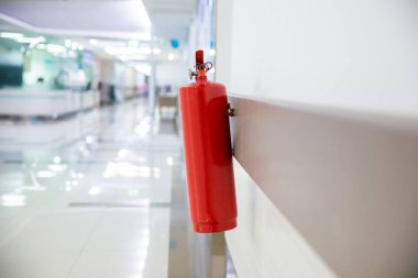 Ameliyathanede yangın söndürücü var. Binanın duvarına bir yangın söndürücü yerleştirin. Koridorda kuru kimyasal barut yangın söndürücü var. Duvarda kırmızı bir yangın söndürücü asılı. .