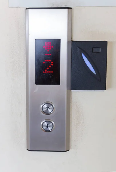 securing lift or elevator access control. elevator access control, Hand holding a key card to unlock elevator floor before up or down.