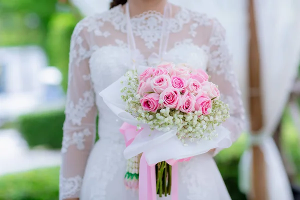 Bride\'s hands with flowers . bouquet in hands of the bride, woman getting ready before wedding ceremony .