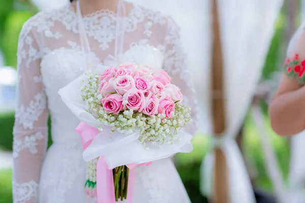 Bride's hands with flowers . bouquet in hands of the bride, woman getting ready before wedding ceremony .