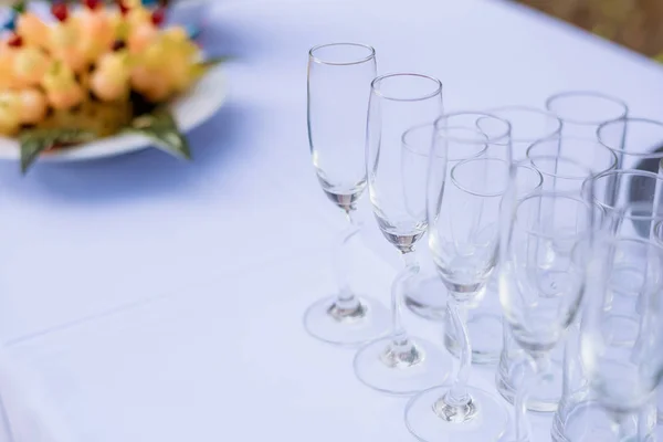 Crystal glasses of champagne on the wedding Reception table. Table setting for an event party or wedding reception at the beach.