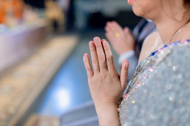 Beautiful Asian girl to pay respect and praying Buddhism worshiping Buddha statue with faith. Hands begging,  clipart