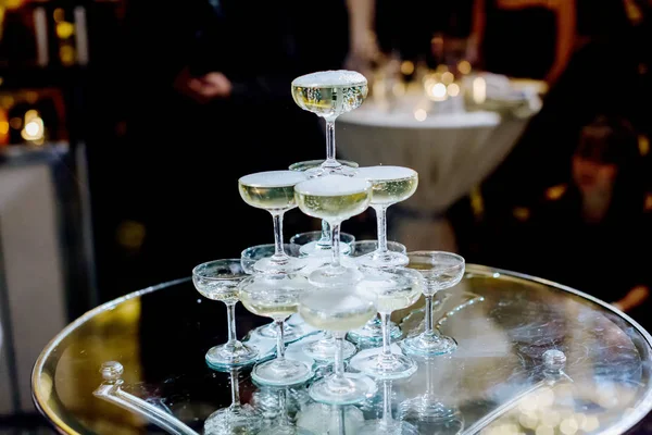 Champagne glass pyramid.pyramid of glasses of wine, champagne, tower of champagne\'s glass in wedding reception party