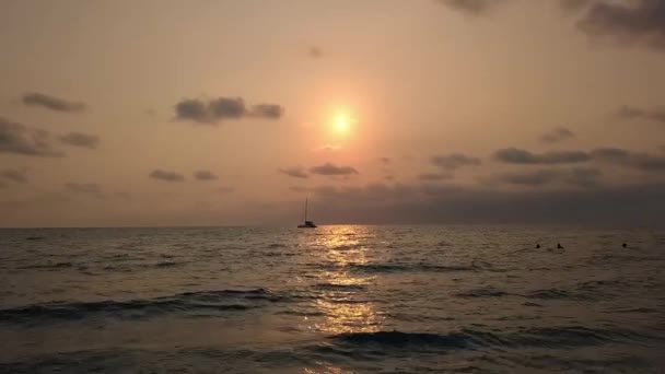日の出時に海の無人機から撮影された空中ビューシルエットのボートセーリングと帆船日没のファンタジー 観光客のヨット 海の夜の散歩海の夕日の間の豪華なヨットでロマンチックな — ストック動画