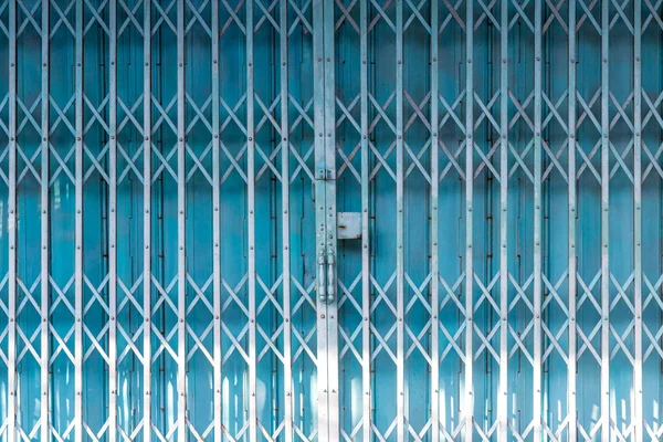 Folding metal house door, Old metallic, Iron door. Blue stretched slide steel airy door at outside with steel sheet lock and dense iron door at inside ,full metal folding Chinese gate.