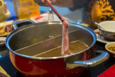 Sukiyaki demliğinde et ve sebze kaynatmak ve buharda pişirmek, sağlıklı olarak haşlanmış yemeği seçmek ve kızarmış yiyeceklerden kaçınmak kavram. Seçici odaklanma Shabu Shabu ve Sukiyaki, Japon yemekleri.