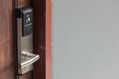 Oteldeki akıllı kart kapısı kilit sistemi. Ahşap kapıdaki otel elektronik kilidi. Elektronik kartı olan giriş kapısı. Otelin korunması için dijital kapı kilitleme sistemleri