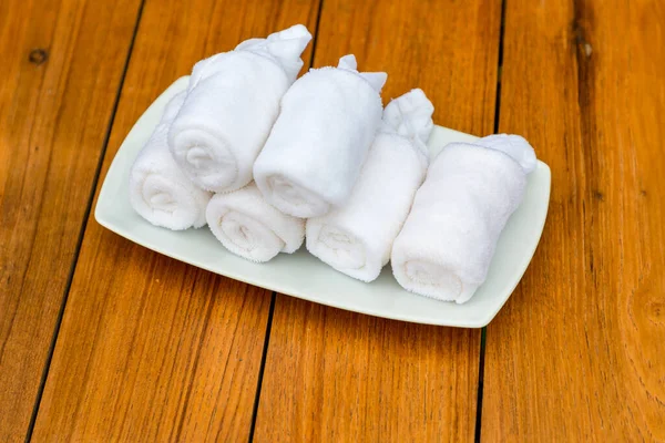 Cold towels, welcome in the hotel. Wet welcoming refreshing towels at the eastern restaurant. Welcome, guest, hygiene, tradition concept. Refreshing towel in welcome drink set.