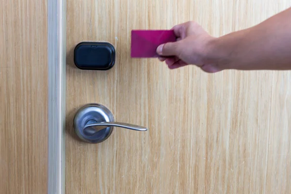 Smart card door key lock system in hotel. Hotel electronic lock on wooden door. Entrance door with electronic card lock security. Digital door lock security systems for access protection of hotel