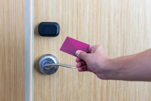 Smart card door key lock system in hotel. Hotel electronic lock on wooden door. Entrance door with electronic card lock security. Digital door lock security systems for access protection of hotel