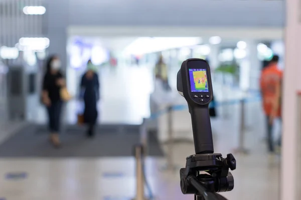 Thermal scanner to check the temperatures of passengers arriving airport. Automatic measuring temperature woman at hospital .Covid-19 test temperature for human.