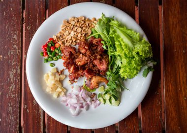 Kızarmış domuz kaburgası, yanında da sarımsak, biber ve fındık. En sevdiği koruma yiyeceği. Kızarmış ekşi domuz eti. Kızarmış mayalanmış domuz pirzolası lezzetli.