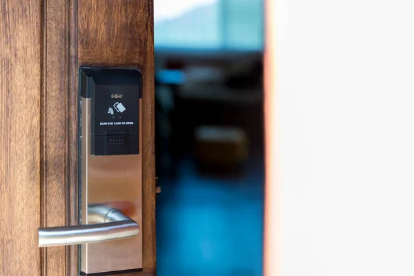 Smart card door key lock system in hotel. Hotel electronic lock on wooden door. Entrance door with electronic card lock security. Digital door lock security systems for access protection of hotel