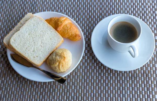 Breakfast with bread, croissants and black coffee composition. breakfast with black coffee and bread.