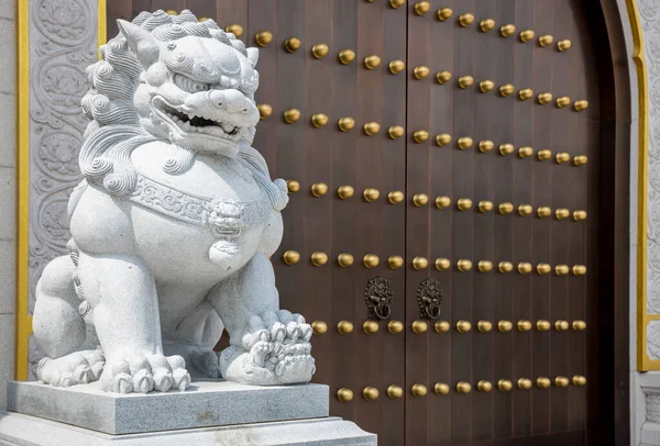 Stone Lion statue in front gate of Temple. Stone lion in China. Stone lion statue of wood gate.