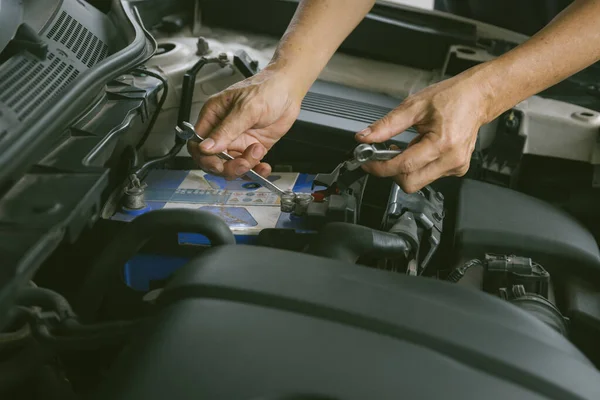 Engine engineer is replacing  car battery because car battery is depleted. concept car maintenance And the cost of car care.