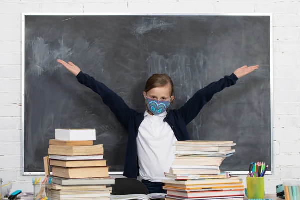 Girl in a protective mask. The student protects the respiratory tract during school hours.