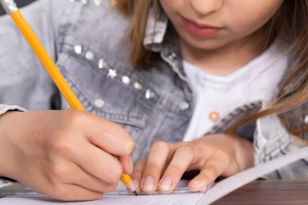 The student uses a ruler and pencil to draw lines that are the solution to the task given in the lesson.