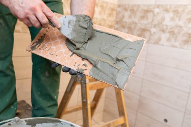 Kalın çimento bazlı yapıştırıcı. İçişleri için profesyonel bir çalışan. Döşemeler - seramik fayans.