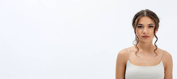 A stunning closeup image of a young woman radiating elegance beautifully against a simple, clean backdrop