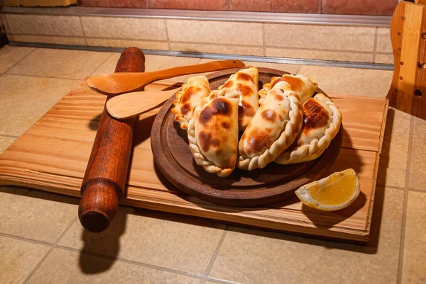 木制餐桌 带有新鲜自制的Empanadas 详细的特写镜头 有选择的焦点 — 图库照片