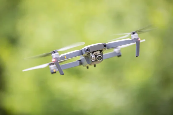 stock image Close-up quadcopter drone with camera flying in park.