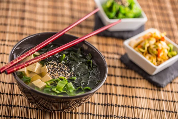 Geleneksel Japon tofu deniz yosunu chopsticks ve Genç soğan ile Miso çorbası.