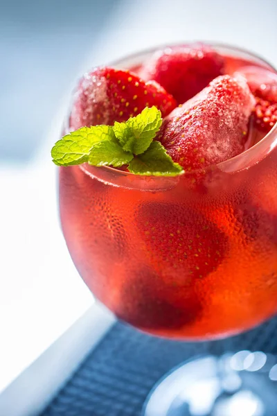 Strawberry lemonade or alcoholic cocktail with ice syrup soda and mint leaves.