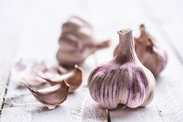 Garlic cloves and bulbs on vintage wooden table.