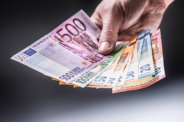 Euro banknot elinde tutan erkek.