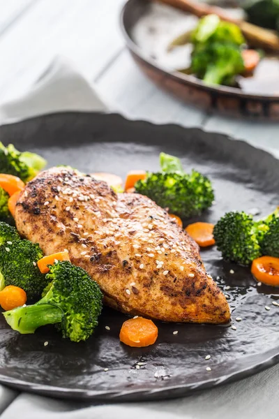 Roasted chicken breast with broccoli carrot and sesame.