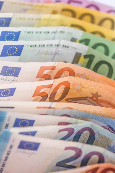 Euro banknotes in detail on the pile of other nominal banknotes.