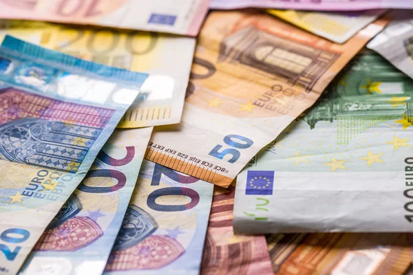 Euro banknotes in detail on the pile of other nominal banknotes.