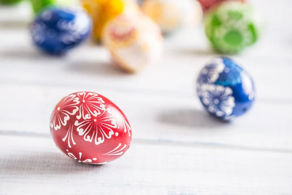 Close-up multicolored easter eggs on wooden table.