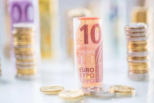 Rolled euro banknotes and coins towers stacked in other position — Stock Photo, Image