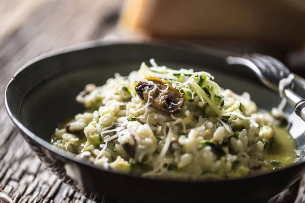 Italiaanse risotto courgette champignons en Parmezaanse kaas in donkere plaat — Stockfoto