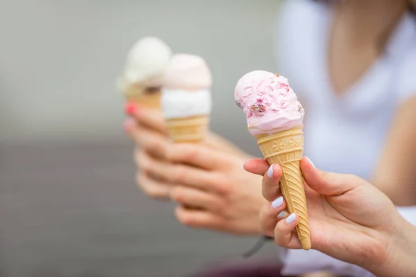 Delicious three ice cream in female hands - close-up. — Stock Photo, Image