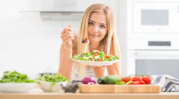 Jovem menina loira feliz comer salada saudável de arugula spinac — Fotografia de Stock