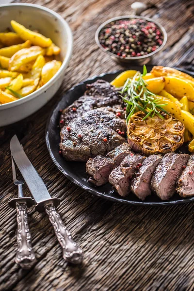 Grilled beef Rib Eye steak with garlic american potatoes rosemary salt and spices — Stock Photo, Image