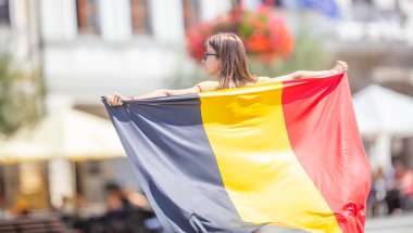 Attractive happy young girl with the Belgian flag clipart