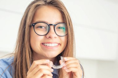 Young girl with dental invisible braces clipart