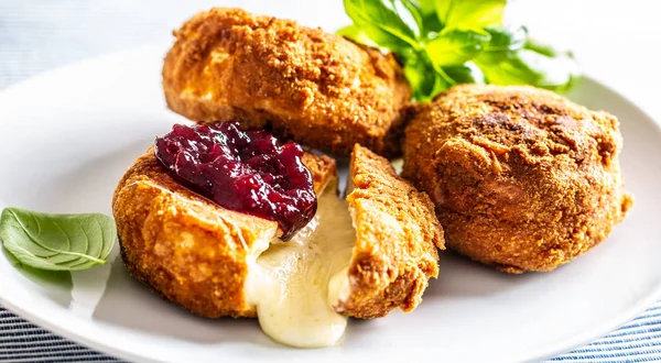 Fried camembert or brie cheese with cranberry jam and basil — Stock Photo, Image
