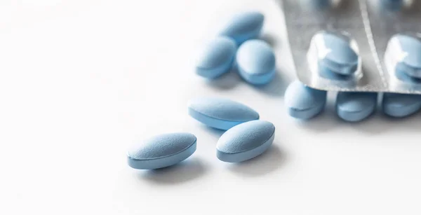 Blue pills loose lying on a white isolated background — Stock Photo, Image