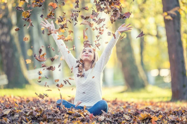 Portrait of a young woman enjoying the autumn atmosphere and pla — Stock Photo, Image