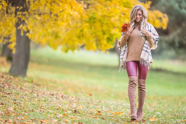 Sonbahar kıyafetli genç kadın parkta duygusal bir yürüyüş yapıyor. — Stok fotoğraf