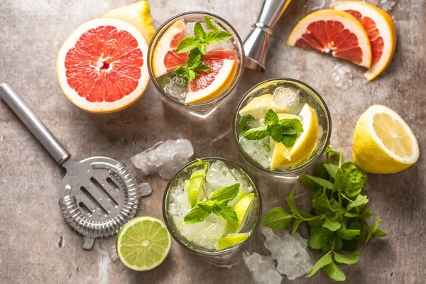 Three colorful gin tonic cocktails in whiskey glasses on bar counter in pup or restaurant — Stock Photo, Image