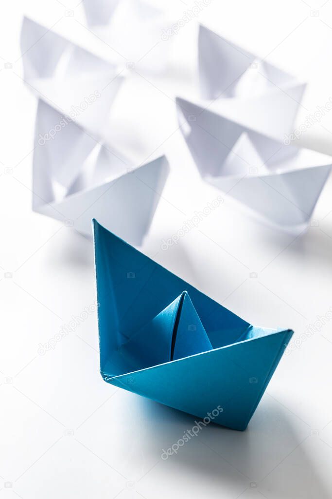 Blue and white paper boats. Concept of leadership boats for teamwork group or success.
