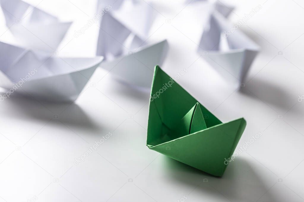 Green and white paper boats. Concept of leadership boats for teamwork group or success.
