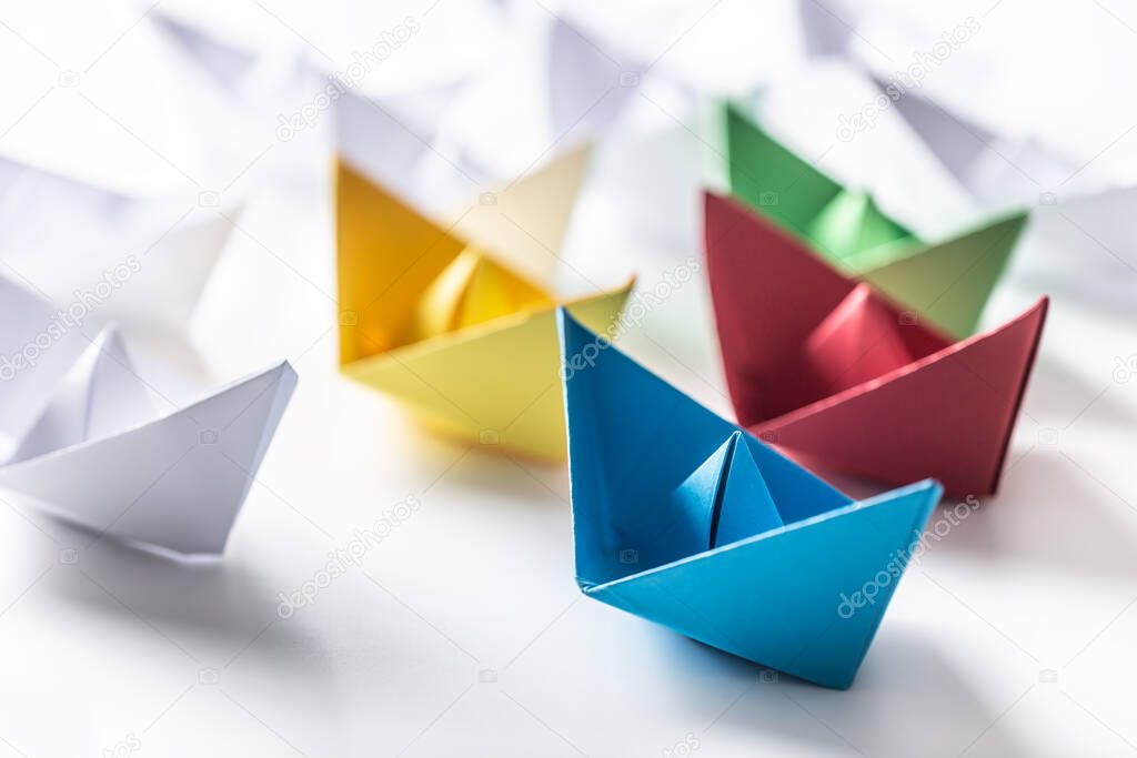 Multi colored paper boats. Concept of leadership boats for teamwork group or success.