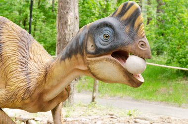 Belgorod, Russia, 20 may 2018 - Dinosaur Park, model of a dinosaur that stole an egg clipart